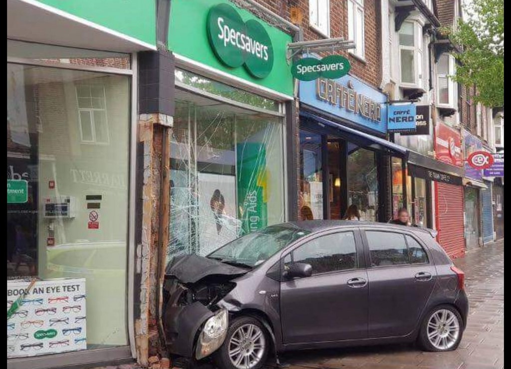 A Car hits Specsavers In Ruislip High Street